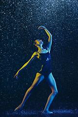 Image showing Two young female ballet dancers under water drops