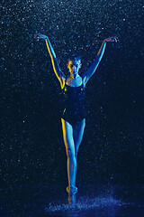 Image showing Two young female ballet dancers under water drops