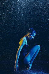 Image showing Two young female ballet dancers under water drops