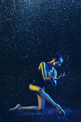 Image showing Two young female ballet dancers under water drops