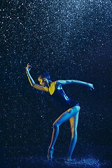 Image showing Two young female ballet dancers under water drops