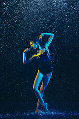 Image showing Two young female ballet dancers under water drops