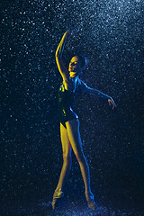 Image showing Two young female ballet dancers under water drops