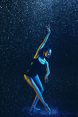 Image showing Two young female ballet dancers under water drops