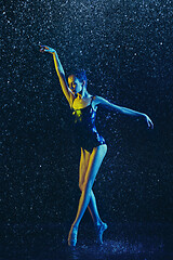 Image showing Two young female ballet dancers under water drops