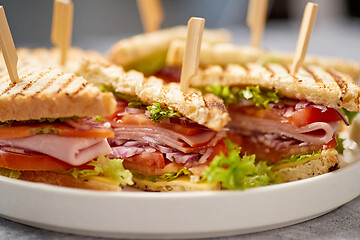 Image showing Close up on appetizing fresh and healthy grilled club sandwiches with ham and cheese