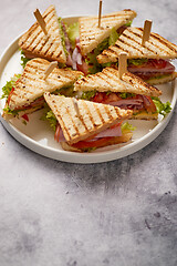 Image showing Appetizing fresh and healthy grilled club sandwiches with ham and cheese