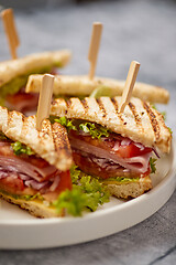 Image showing Appetizing fresh and healthy grilled club sandwiches with ham and cheese