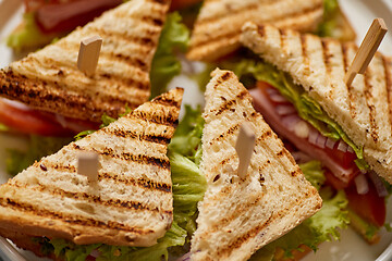 Image showing Close up on appetizing fresh and healthy grilled club sandwiches with ham and cheese