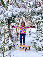 Image showing Girl with sled in winter forest