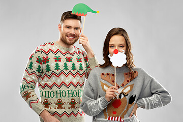 Image showing couple with christmas party props in ugly sweaters