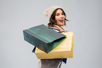 Image showing young woman in winter hat with shopping bags