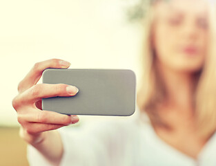 Image showing close up of woman taking selfie by smartphone