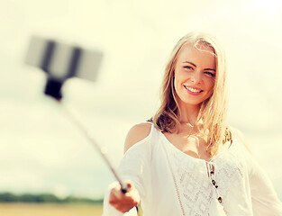 Image showing happy young woman taking selfie by smartphone