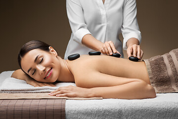 Image showing beautiful woman having hot stone massage at spa