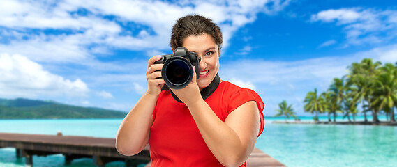 Image showing happy woman photographer with camera on vacation