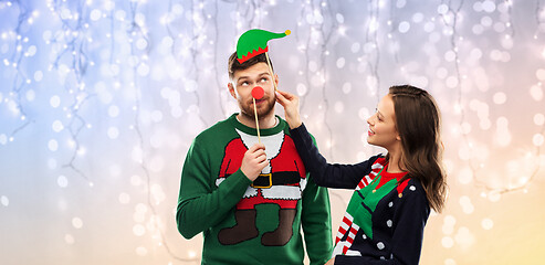 Image showing couple with christmas party props in ugly sweaters