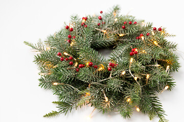 Image showing christmas fir wreath with berries and lights