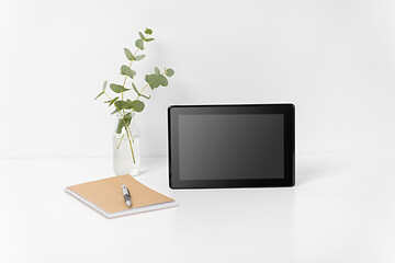 Image showing tablet pc with black screen on white office table