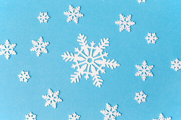 Image showing white snowflake decorations on blue background