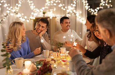 Image showing family with sparklers having dinner party at home