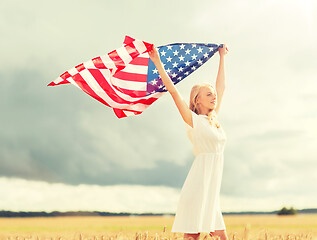 Image showing happy woman with american flag on cereal field