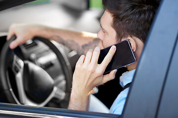 Image showing man driving car and calling on smartphone