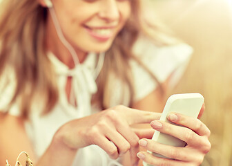 Image showing close up of woman with smartphone and earphones