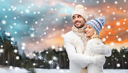 Image showing smiling couple in winter clothes hugging