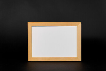 Image showing white board in wooden frame on black background