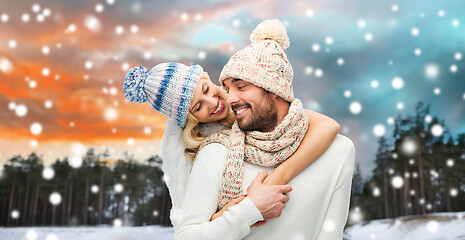 Image showing smiling couple in winter clothes hugging