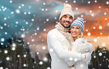 Image showing smiling couple in winter clothes hugging