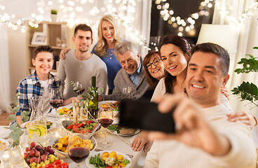 Image showing family having dinner party and taking selfie