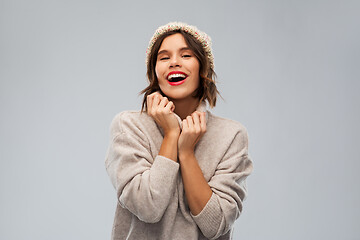 Image showing young woman in knitted winter hat and sweater