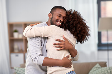 Image showing happy african american couple hugging at home