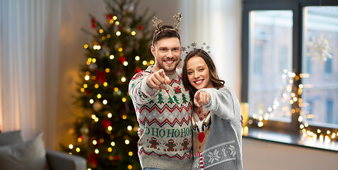 Image showing happy couple at christmas ugly sweater party