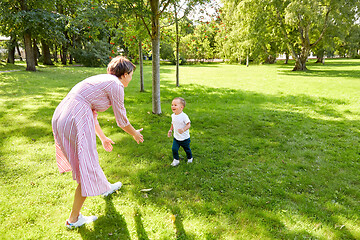 Image showing happy mother and son having fun at summer park