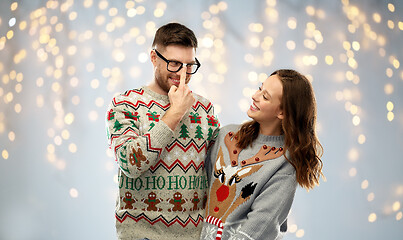 Image showing happy couple at christmas ugly sweater party