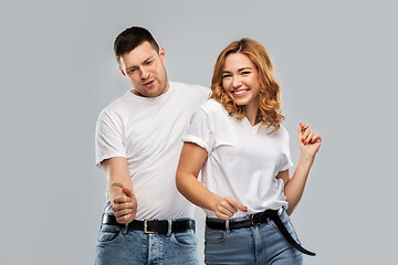 Image showing portrait of happy couple in white t-shirts dancing
