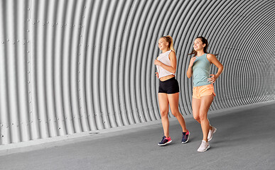 Image showing young women or female friends running outdoors