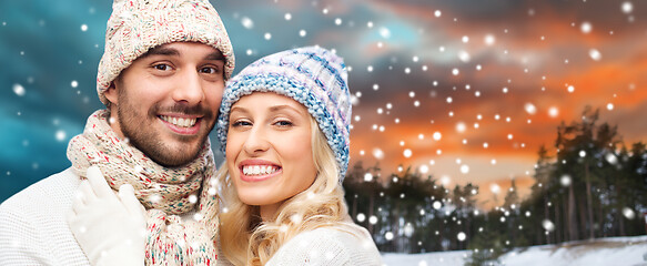 Image showing smiling couple in winter clothes hugging