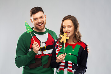 Image showing couple with christmas party props in ugly sweaters