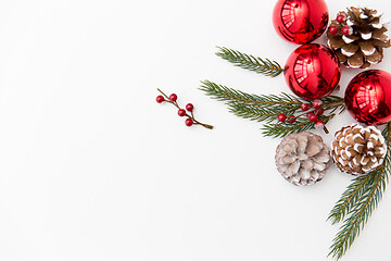 Image showing christmas balls and fir branches with pine cones