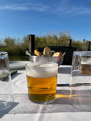 Image showing Glass of beer on the cafe table