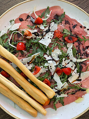 Image showing Salad with jamon served with breadsticks