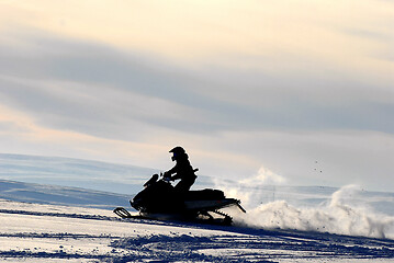 Image showing Silhouette on snow-scooter