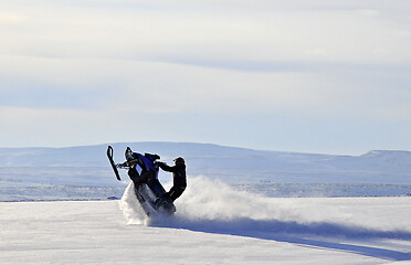 Image showing Making tricks on his snow scooter