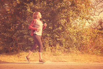 Image showing woman jogging along a country road