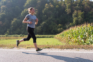 Image showing woman jogging along a country road