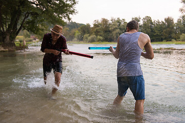 Image showing young men having fun with water guns